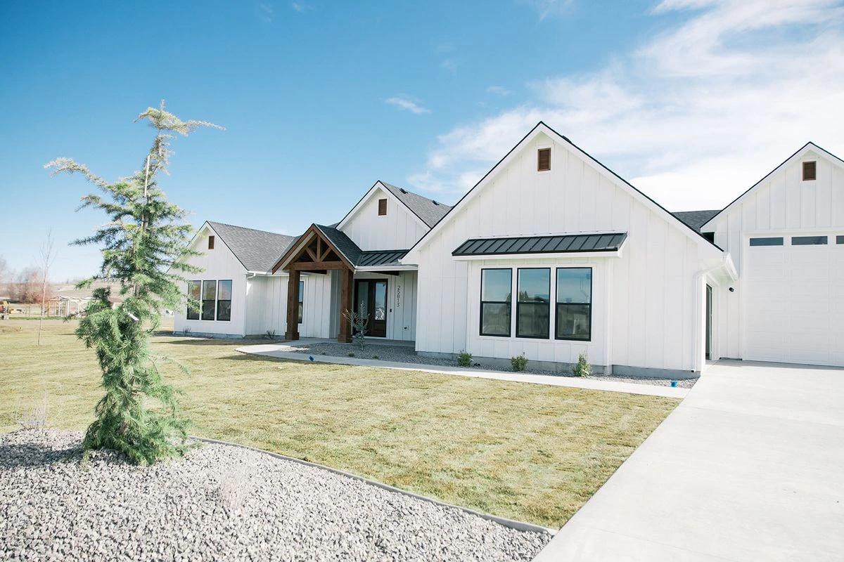 White custom home exterior with modern farmhouse details in Emmett, Idaho
